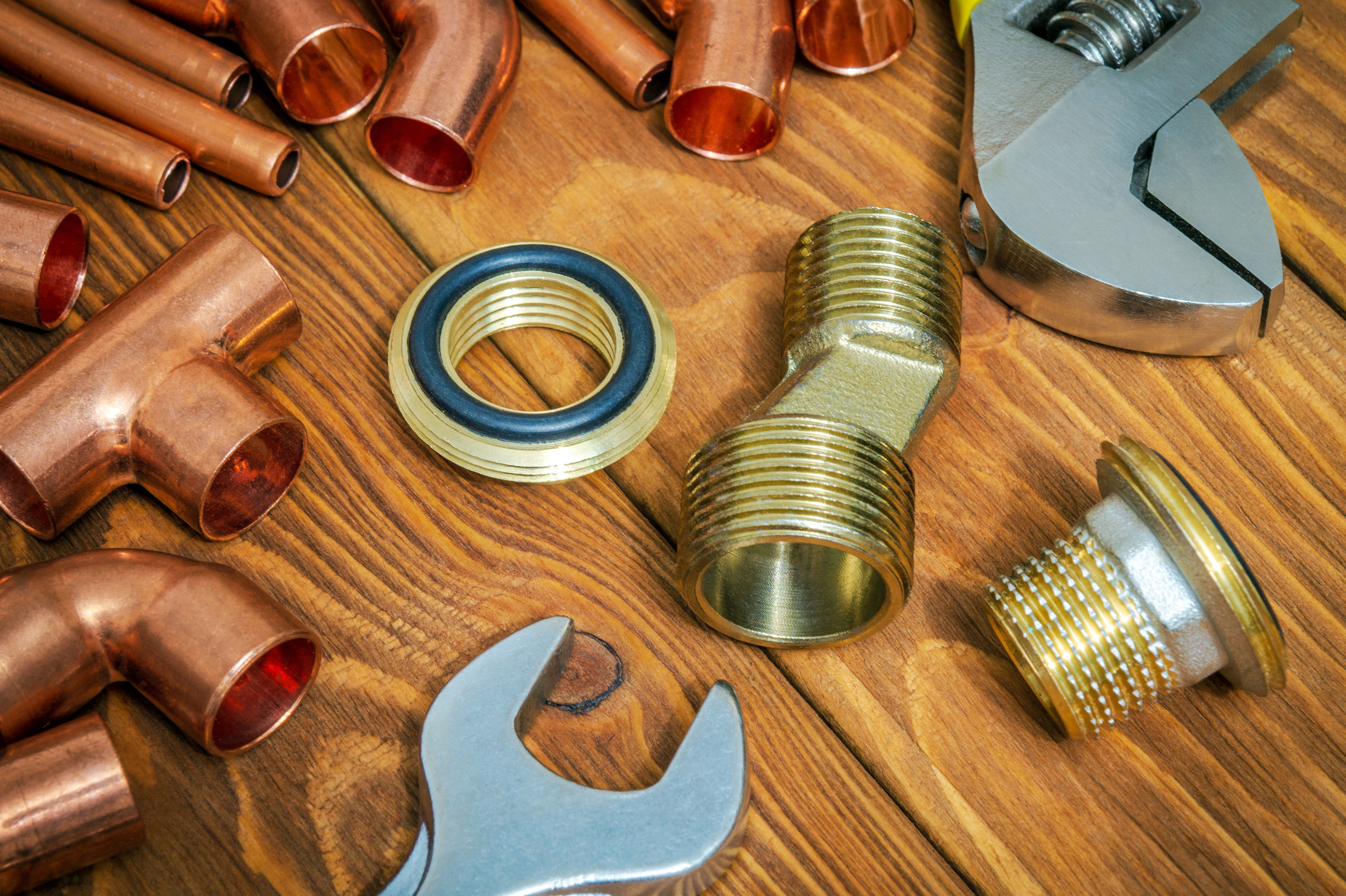 The spare parts with copper and brass accessories for plumbing repair on vintage wooden boards